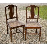 An old pair of cane seat bedroom side chairs (2)