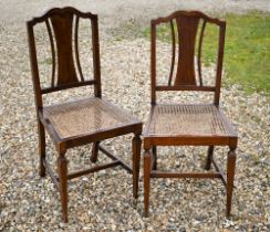 An old pair of cane seat bedroom side chairs (2)