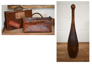 An antique lead-weighted exercise skittle, 65 cm high, to/w a small vintage leather Gladstone bag