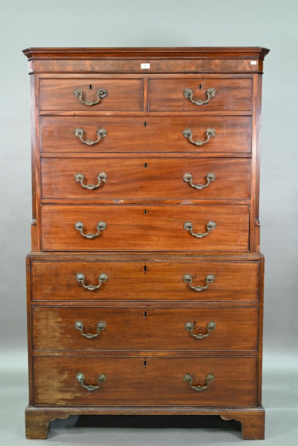 An associated two part George III mahogany chest on chest, the upper chest with canted pilasters,