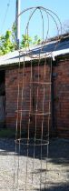 A weathered steel sweet pea garden frame with separate sphere top, approx. 227 cm h