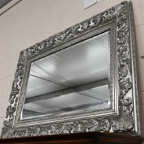 A large Victorian style silver framed bevel edged mirror, 122 cm x 92 cm