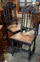 A pair of late Victorian Gothic revival carved oak side chairs