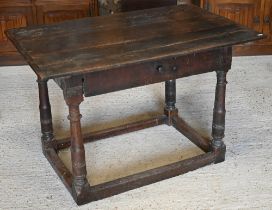 A provincial 17th century oak and elm side table with cleated three-plank top over frieze drawer and