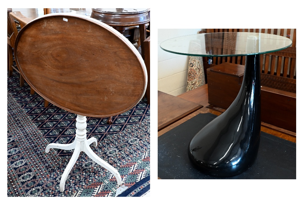 A contemporary glass-top side table with black high gloss 'tear drop' fibreglass base, 50 cm diam