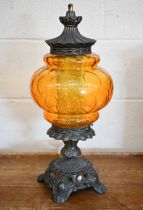 An ornate brass table lamp with moulded amber glass shade, 56 cm