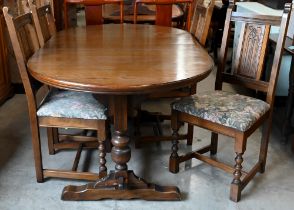 A 'Wood Brothers' Old Charm extending dining table with leaf, on turned pillars tied with a