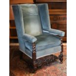 An antique oak framed wingback armchair in blue dralon upholstery, 80 cm w x 55 cm d x 176 cm h o/a