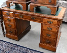 An Edwardian walnut twin pedestal desk with inset green leather top over nine drawers, 122 cm wide x