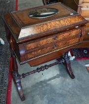 A Victorian walnut sewing table with hinged top enclosing maple fitted interior with turned supports