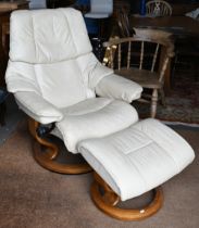 An Ekornes Stressless cream leather reclining armchair amd matching footstool, a/f