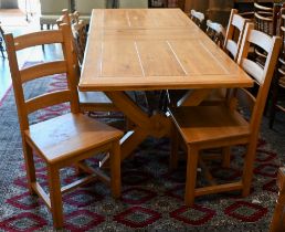 A modern hardwood draw-leaf extending dining table, the cleated top opening to accept two central