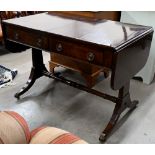 A Regency mahogany sofa table with two drawers, rectangular supports with splayed legs terminating