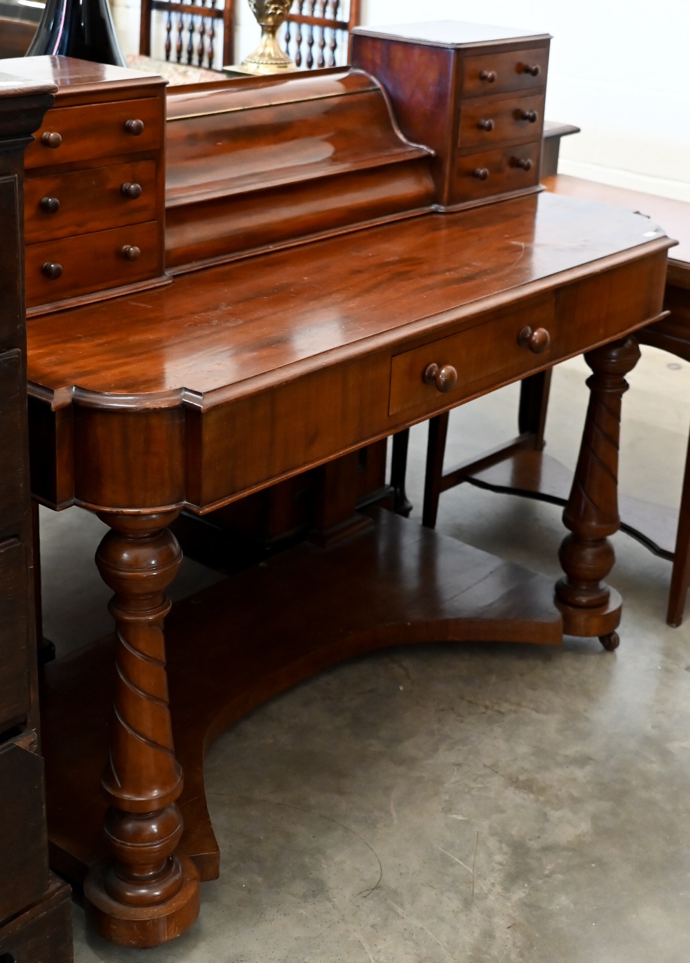 A Victorian mahogany dressing table on spiral fluted supports joined by concaved platform base,