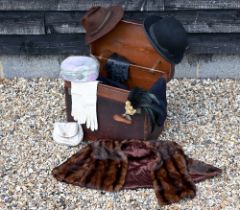 A leather boot-trunk containing a quantity of costume, including a vintage child's sailor suit by