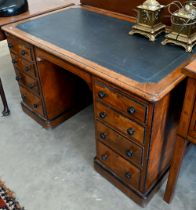A late Victorian Aesthetic movement oak eight drawer desk with turned ebony handles and inset