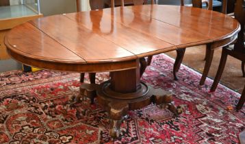 A late 19th century mahogany extending circular dining table on tapering octagonal column and