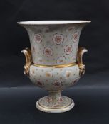A 19th century porcelain vase campana vase of flared form with twin handles on a pedestal foot,
