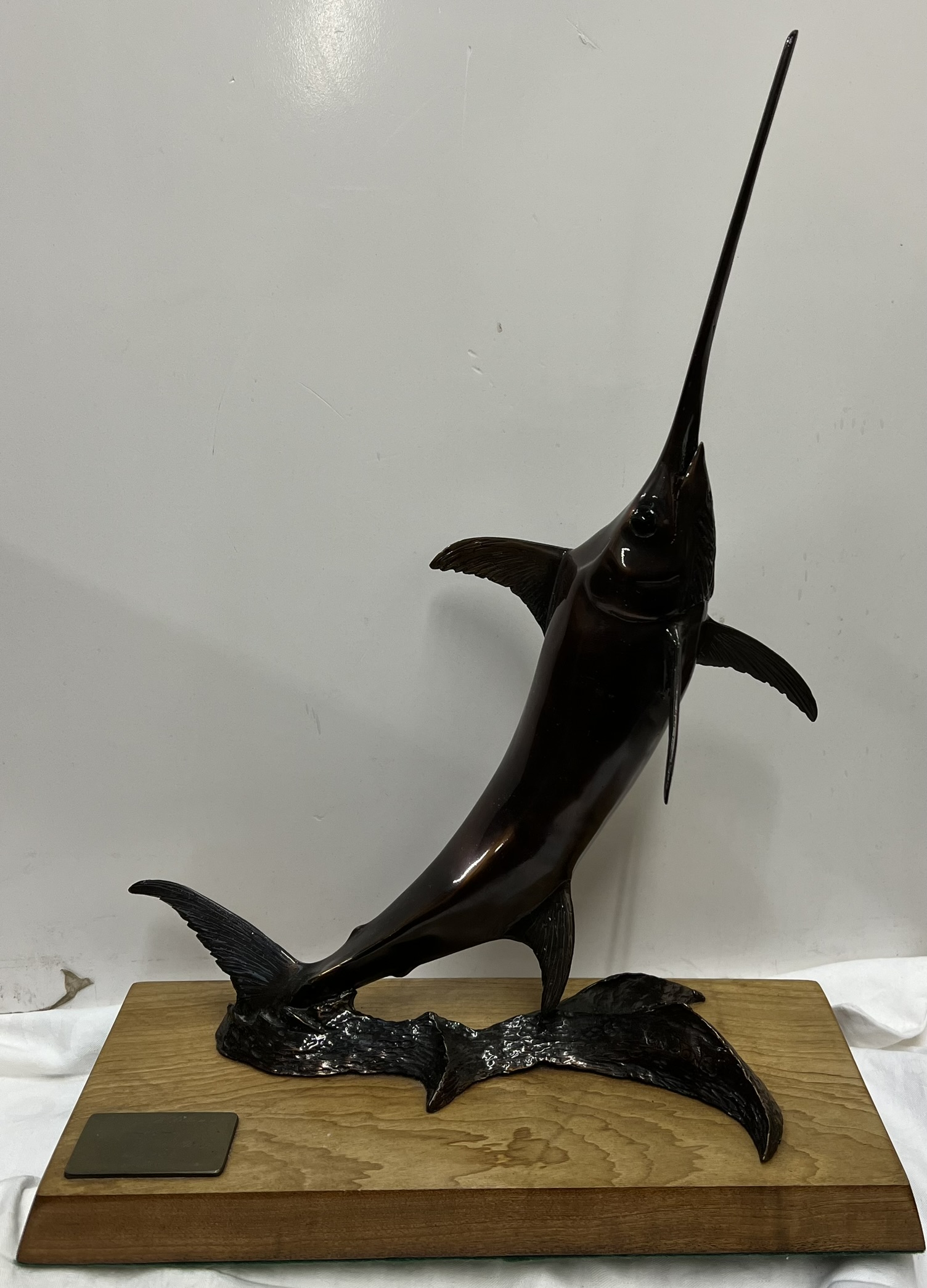 Len Jones (South African) A Bronze Marlin Mounted on a wooden base Signed Bears a plaque "Danny