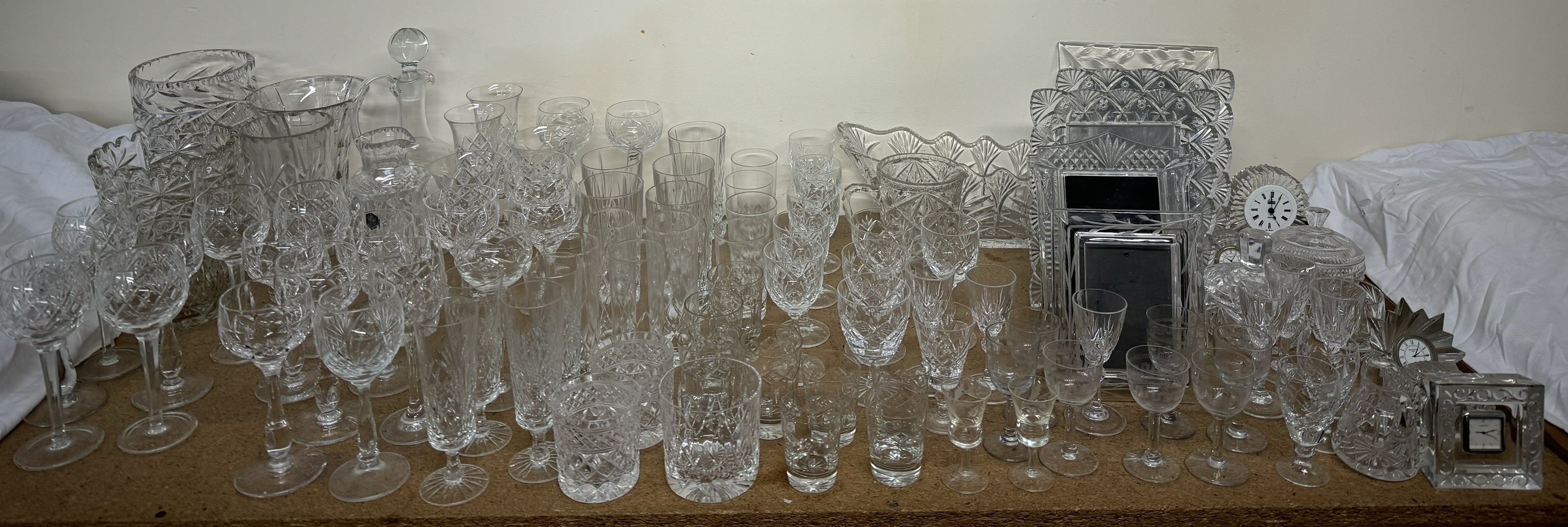 Assorted crystal drinking glasses together with crystal vases, crystal photograph frames,