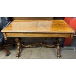 A Victorian walnut library table with a rectangular top above two drawers on turned supports and