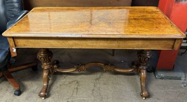 A Victorian walnut library table with a rectangular top above two drawers on turned supports and