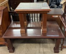 A reproduction mahogany coffee table with a rectangular top and inlaid glass panel on square legs