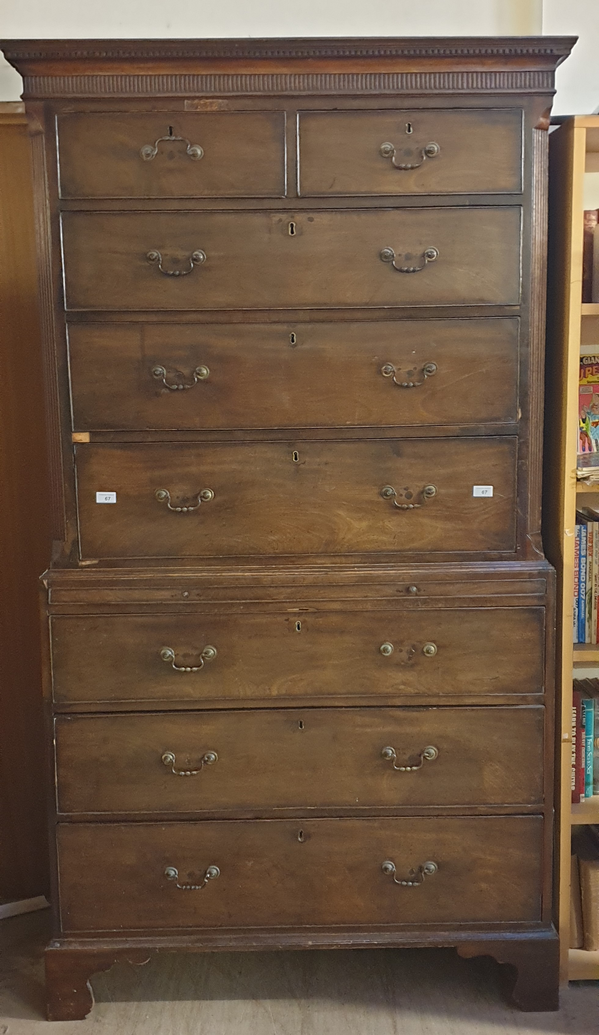 A George III mahogany chest on chest with a moulded dentil cornice above two short and three long