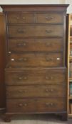 A George III mahogany chest on chest with a moulded dentil cornice above two short and three long