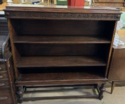 A late 19th century oil bookcase with a rectangular top above three shelves on turned legs united