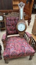 An Edwardian carved oak gentleman's library chair together with an oak cased barometer