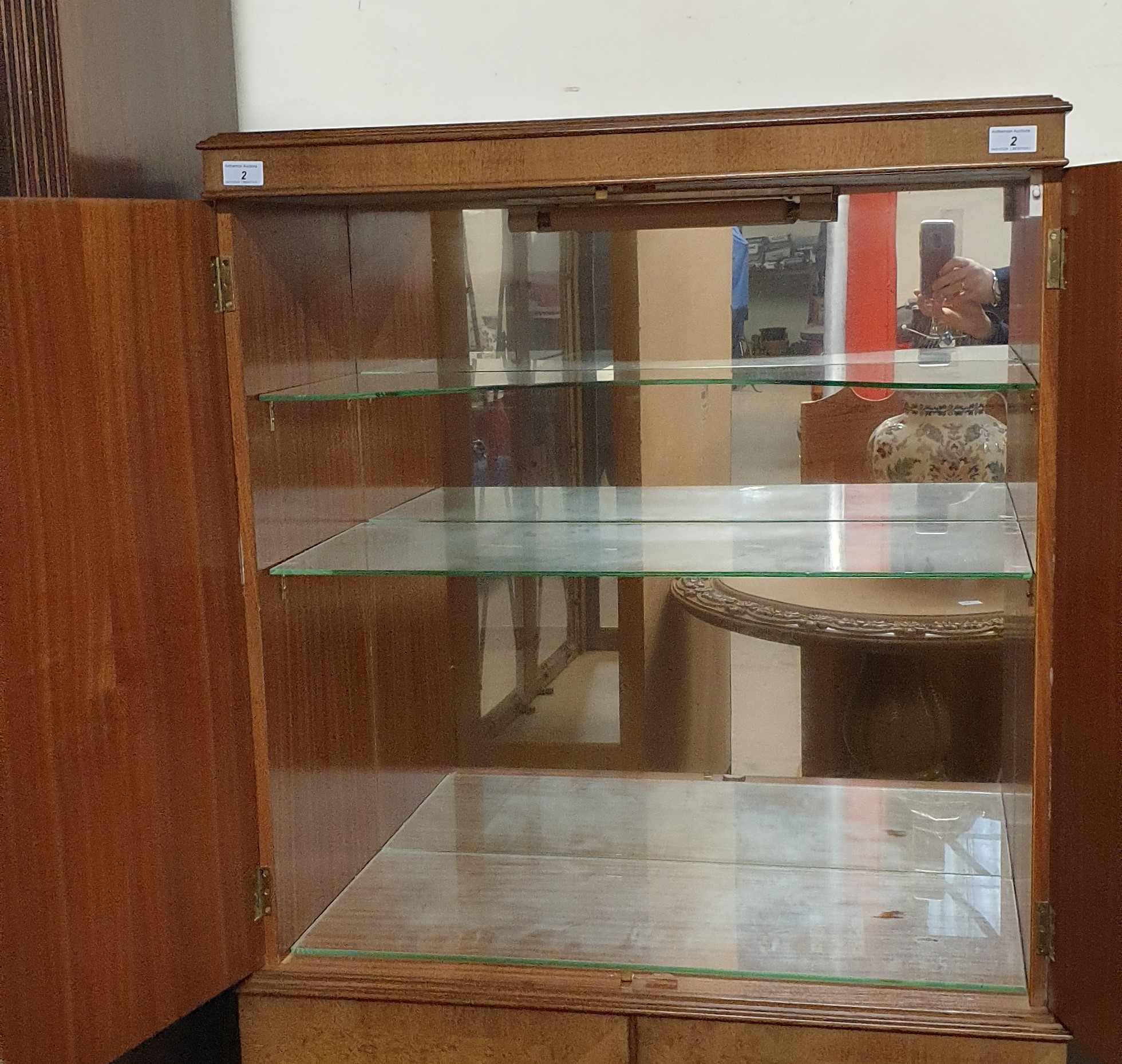 A 20th century walnut cocktail cabinet with a pair of cabinet doors enclosing a shelved mirrored - Image 2 of 6