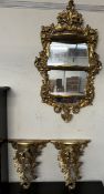 A carved gilt wall mirror with a leaf cresting and three shelves together with a pair of gilt