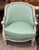 A Continental upholstered tub chair with cream frame and green floral upholstery