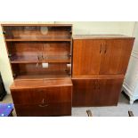 A modern teak office display cabinet with cupboards to the base together with a matching four door