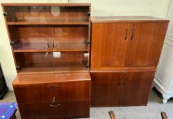 A modern teak office display cabinet with cupboards to the base together with a matching four door