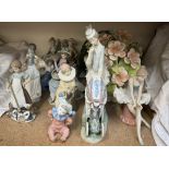 A large Lladro figure group of a lady pushing a pram together with Lladro,