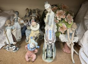 A large Lladro figure group of a lady pushing a pram together with Lladro,