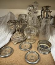 An electroplated epergne together with electroplated and glass claret jugs, decanters, ice buckets,