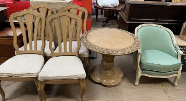 A carved modern dining table and four chairs together with an upholstered arm chair and a 20th