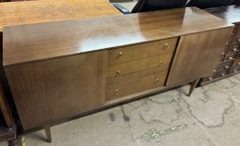 A mid 20th century teak sideboard with a rectangular top above three drawers and two cupboards on