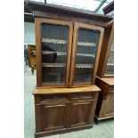 A Victorian mahogany bookcase with a moulded cornice above a pair of glazed doors,