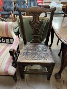 A 19th century carved oak dining chair with a vase splat and carved seat on squarer legs