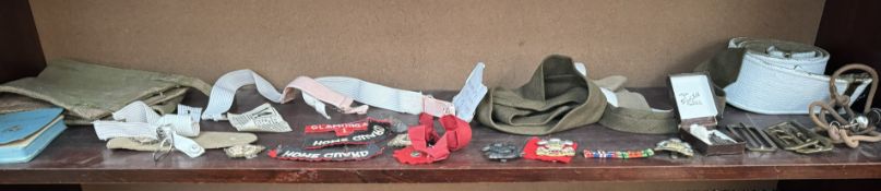 Military cap badges together with belts etc