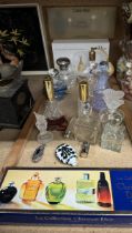 A silver topped and glass scent bottle together with a collection of scent bottles etc