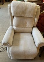 A cream coloured upholstered electric reclining chair
