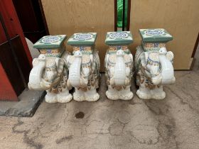 A set of four pottery elephant garden seats