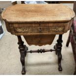A Victorian walnut sewing / work table with a shaped top enclosing a writing surface above a