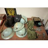 A Welsh seal skin hat together with military tin helmets, gas masks,