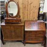 A reproduction mahogany bureau together with a walnut television cabinet and a dressing table